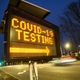 A digital sign directs people to the drive-through coronavirus testing area, which began on the main campus of Stony Brook University on March 18, 2020.